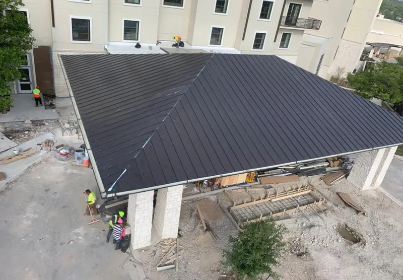 Metal roofing installation team working on a commercial building in Medulla